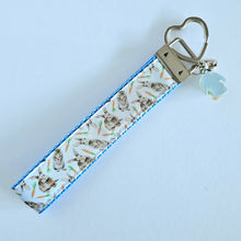 Load image into Gallery viewer, Bunnies with Carrots on White Heart Key Fob Wristlet on Silver or Rainbow