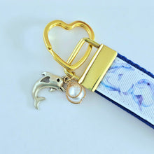 Load image into Gallery viewer, Dolphins in Watercolor on Yellow Gold Key Chain Fob with Gold Dolphin Charm
