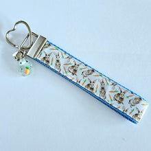 Load image into Gallery viewer, Bunnies with Carrots on White Heart Key Fob Wristlet on Silver or Rainbow