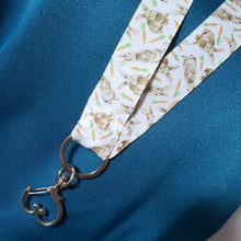 Load image into Gallery viewer, Bunnies with Carrots on White Lanyard with Silver Heart Clasp