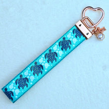 Load image into Gallery viewer, Glittery Sea Turtles Honu on Gold Key Chain Fob with Turtle &amp; Pearl or Starfish Charm

