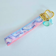 Load image into Gallery viewer, Dolphins in Watercolor Pink Blue Waters on Yellow Gold Key Chain Fob  with Dolphin Charm
