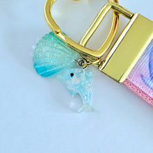 Load image into Gallery viewer, Dolphins in Watercolor Pink Blue Waters on Yellow Gold Key Chain Fob  with Dolphin Charm
