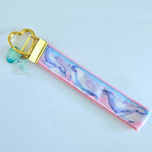 Load image into Gallery viewer, Dolphins in Watercolor Pink Blue Waters on Yellow Gold Key Chain Fob  with Dolphin Charm

