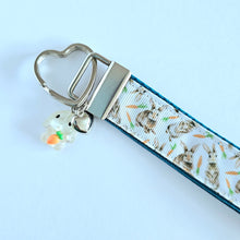 Load image into Gallery viewer, Bunnies with Carrots on White Heart Key Fob Wristlet on Silver or Rainbow
