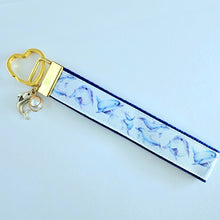 Load image into Gallery viewer, Dolphins in Watercolor on Yellow Gold Key Chain Fob with Gold Dolphin Charm
