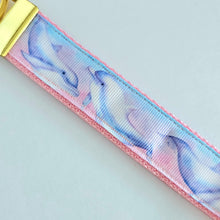 Load image into Gallery viewer, Dolphins in Watercolor Pink Blue Waters on Yellow Gold Key Chain Fob  with Dolphin Charm
