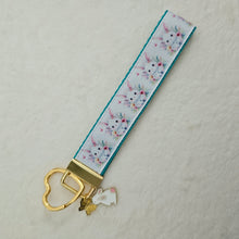 Load image into Gallery viewer, Watercolor Floral White Bun with Bunny and Flower Charms
