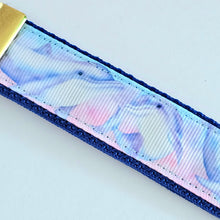 Load image into Gallery viewer, Dolphins in Watercolor Pink Blue Waters on Yellow Gold Key Chain Fob  with Dolphin Charm
