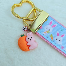 Load image into Gallery viewer, Bunnies with Carrots &amp; Flowers on Light Blue Yellow Gold Key Chain Fob with Enameled Bunny Charm
