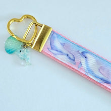 Load image into Gallery viewer, Dolphins in Watercolor Pink Blue Waters on Yellow Gold Key Chain Fob  with Dolphin Charm
