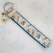 Load image into Gallery viewer, Bunnies with Carrots on White Key Fob Wristlet on Silver or Rainbow
