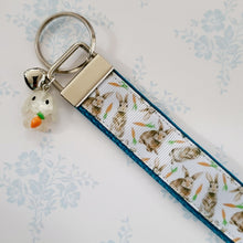Load image into Gallery viewer, Bunnies with Carrots on White Key Fob Wristlet on Silver or Rainbow
