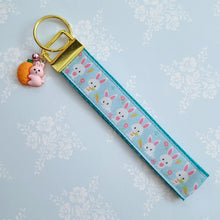 Load image into Gallery viewer, Bunnies with Carrots &amp; Flowers on Light Blue Yellow Gold Key Chain Fob with Enameled Bunny Charm
