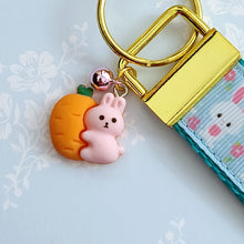 Load image into Gallery viewer, Bunnies with Carrots &amp; Flowers on Light Blue Yellow Gold Key Chain Fob with Enameled Bunny Charm

