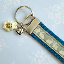 Load image into Gallery viewer, Bunnies In Love on Blue Keychain Fob with Cute Bunny Charm
