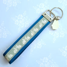 Load image into Gallery viewer, Bunnies In Love on Blue Keychain Fob with Cute Bunny Charm
