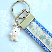 Load image into Gallery viewer, Bunnies In Love on Blue Keychain Fob with Cute Bunny Charm
