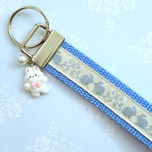 Load image into Gallery viewer, Bunnies In Love on Blue Keychain Fob with Cute Bunny Charm
